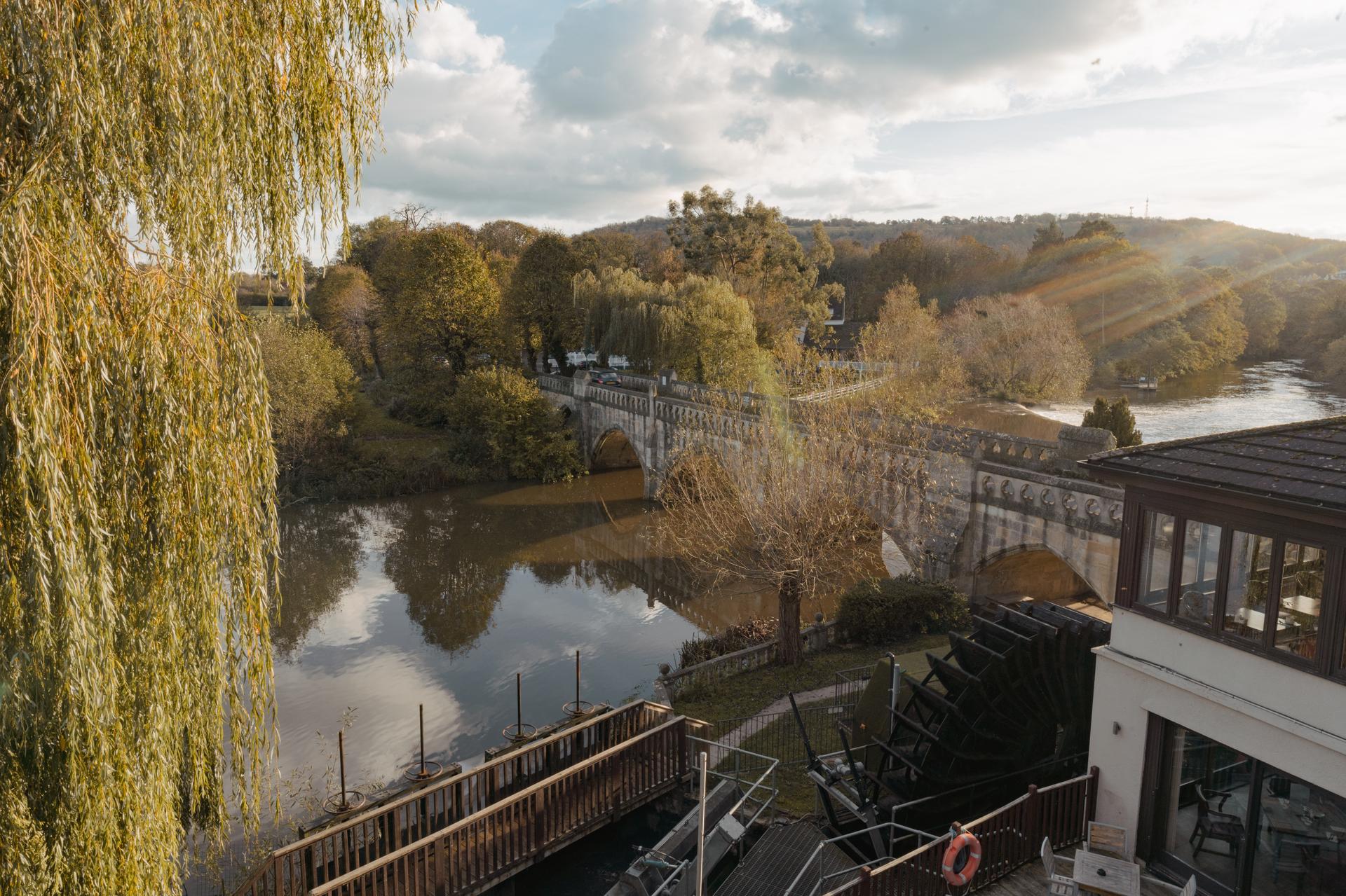 Riverside view of The Avon and Ember restaurant with Toll Bridge over the River Avon at Batheaston